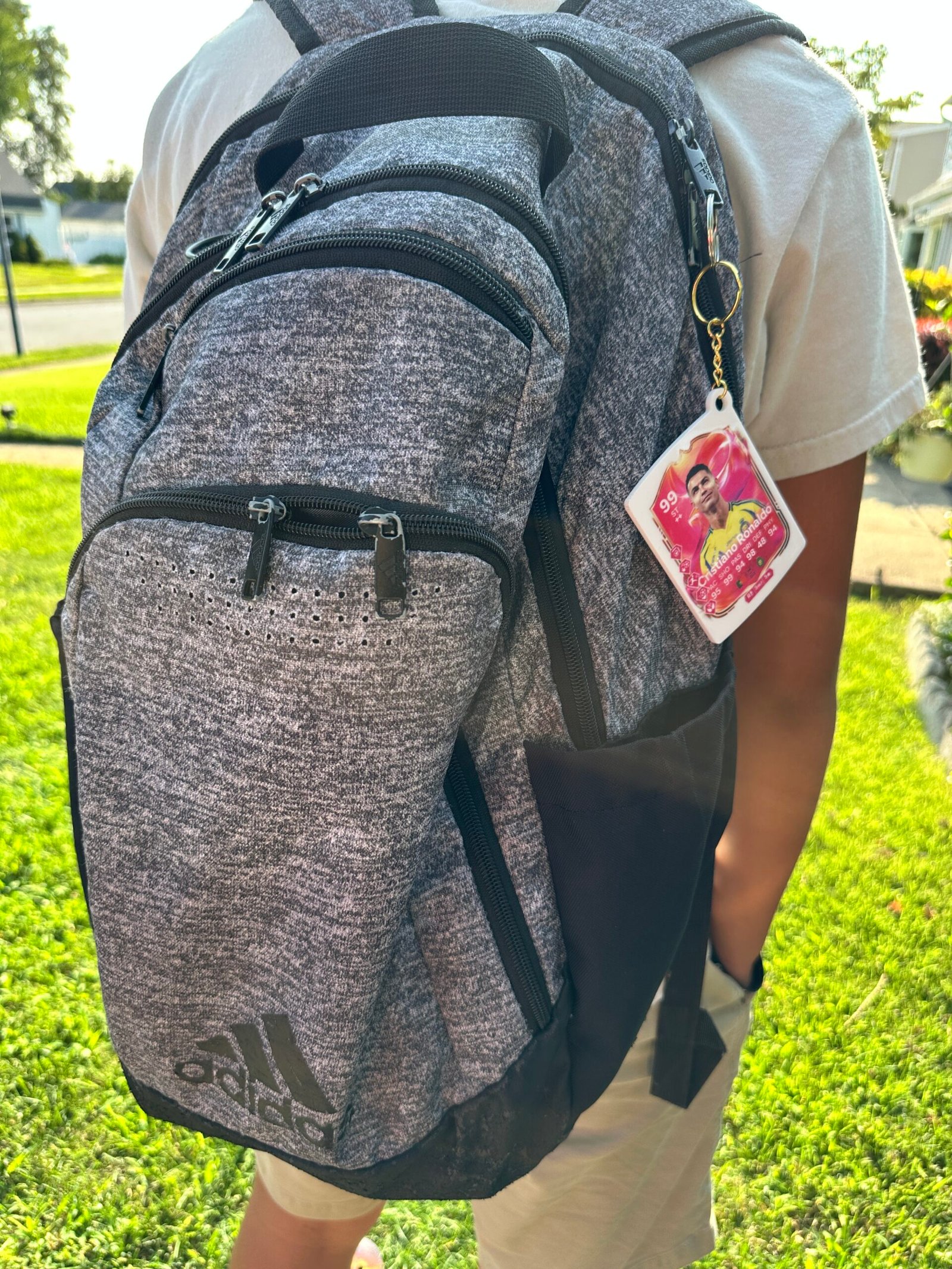 Custom FIFA card keychain attached to Adidas gray backpack personalized football gift accessory